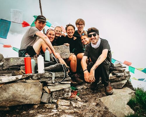 group-picture-of-men-and-women-on-hill-at-daytime